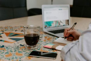 Man sitting at desk working on a laptop writing SEO for Hawaii businesses.